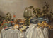 Kleine ontbijttafel of zilverwerk en glaswerk op een gedrapeerde tafel met wijnstokken, fruit en gebak - Pieter Claesz — weergave van het kunstwerk