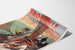 Vintage Normandië-poster – Trouville, gemeentelijk casino, gepresenteerd op een gebogen vel, schuin gefotografeerd.