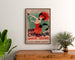 Vintage reclameposter Champagne Damery-Épernay, ingelijst boven een houten dressoir, tussen planten.