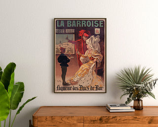 Vintage La Barroise advertisement, framed above a wooden dresser between plants.