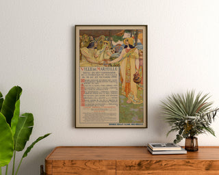 Vintage Marseille poster, Fêtes du Centenaire, framed above a wooden dresser between plants.